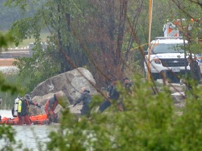 Emergency crews in Brampton pull the lifeless body of a 40-year-old father of two from Professor's Lake on May 30, 2015. (Pascal Marchand/Special to the Toronto Sun)
