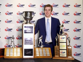 Erie Otters' Connor McDavid poses with the Top Draft Prospect, the CHL MVP and the Scholastic Player trophies during a photo-op before the Canadian Hockey League awards ceremony at the Chateau Frontenac in Quebec City, May 30, 2015. (REUTERS/Mathieu Belanger)