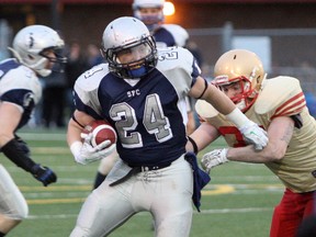 Sudbury Spartans running back Scott Smith tries to fight through a tackle during action against the Sarnia Imperials on Saturday. Ben Leeson/The Sudbury Star/Postmedia Network