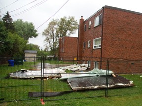 A small walk-up apartment building at 149 Godfrey Ave. in London had its roof blown off in Saturday's storm, leaving the upper floor apartments exposed to the constant rain on Sunday. Mike Hensen/The London Free Press/Postmedia Network