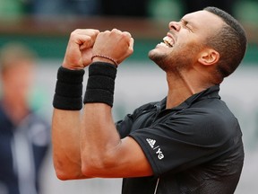 Jo-Wilfried Tsonga of France celebrates after beating Tomas Berdych of the Czech Republic during their men's singles match at the French Open tennis tournament at the Roland Garros stadium in Paris, France, May 31, 2015. (REUTERS/Pascal Rossignol)