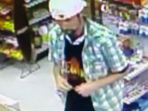 Suspect wanted by Kingston Police for allegedly stealing a Canon camera and a credit card. He is shown here using the credit card at Merry Market in Kingston. Supplied Photo