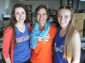 Bayridge Secondary School teacher Carol Allmendinger, centre, at the school in Kingston, Ont. on Fri., May 29, 2015, helped students Bethany Delve, left, and Sydney Stewart, along with other members of the school's Destination Imagination team, compete at world championships in Tennessee recently. Michael Lea/The Whig Standard/PostMedia Network