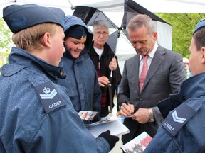 Former Canadian astronaut and Sarnia native Chris Hadfield signs autographs for local air cadets during the rededication ceremony for the Golden Hawk held in Germain Park Sunday. Hadfield, who is a former air cadet, credits the Golden Hawks -- Canada's 1960s-era aerobatics team -- for inspiring him to dream big. (Barbara Simpson/Sarnia Observer/Postmedia Network)