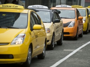 Taxi cabs line up along the street. (File photo)