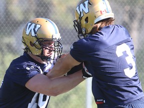 Winnipeg Blue Bombers linebacker Sam Hurl (l) works out against linebacker Graig Newman during CFL football practice in Winnipeg, Man. Sunday May 31, 2015.