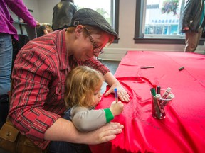 Kat Stoughton and her daughter Lili, 5, write messages on a cape during a day of support for Ontario's new sex-education curriculum held at the 519 centre near Church and Wellesley Sts. in Toronto Sunday May 31, 2015. (Ernest Doroszuk/Toronto Sun)