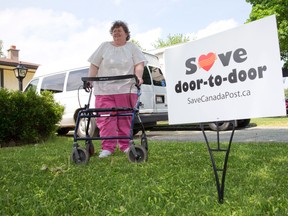 Londoner Joyce Balaz, who is a primary caregiver and uses a walker, is applying to Canada Post to save her door-to-door mail delivery. (Craig Glover / The London Free Press)