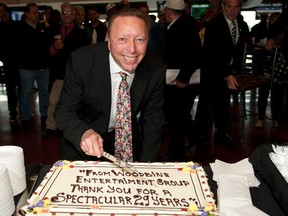 Dan Loiselle poses at the track after being presented with a farewell cake. (MICHAEL BURNS/PHOTO)