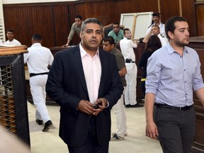Al-Jazeera television journalists Mohamed Fahmy, left, and Baher Mohamed are seen at a court in Cairo after their retrial, April 22, 2015. Fahmy and Mohamed were sentenced last year to between 7 and 10 years in prison for aiding a "terrorist organization," a reference to the Islamist Muslim Brotherhood which was ousted from power by the army in mid-2013. REUTERS/Shadi Bushra
