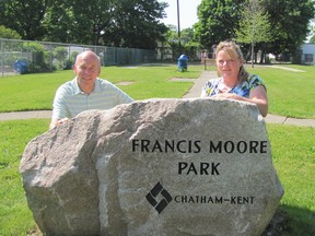 Dr. Bruce Warwick, a cemetery restoration volunteer who wanted to properly honour one of Chatham's most generous late citizens, and Deb Veccia, supervisor of parks and horticulture, pose with an engraved stone that has been placed at the entrance to Francis Moore Park on Lorne Avenue. (Don Robinet, Postmedia Network)