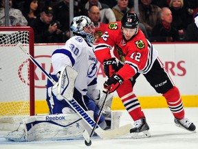 Chicago Blackhawks centre Peter Regin (12) tries to shoot on Tampa Bay Lightning goalie Ben Bishop (30) during the first period earlier this season at the United Center. (David Banks-USA TODAY Sports)