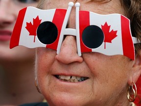 A woman wears sunglasses in the shape of Canadian flags during Canada Day celebrations on Parliament Hill on July 1, 2014. Canadians are celebrating their country's 148th birthday this year on July 1, 2015.
REUTERS/Chris Wattie