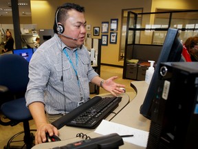 Teletriage nurse Andrew Abella takes a call at a Health Link Alberta call centre in south Calgary in this file photo dated January 21, 2014. Health Link will now be accessible by dialing 811. (Lyle Aspinall/Calgary Sun)