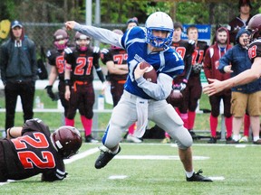 Sudbury Gladiators quarterback Chris Moutsatsos (14) scrambles to avoid Nipissing Wild players during Ontario Football Conference action last season. The Glads will be without Moutsatsos' services for this weekend's contest against North Halton. Sudbury Star/Postmedia Network