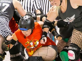 Belleville Bombshells player, AppleSass, knocks down a Renfrew Valley Valkyries player during the Bombshells season opener at the RCAF Arena on Saturday May 30, 2015 in Belleville, Ont.  The final score was 170-117 for Renfrew. Tim Miller/The Intelligencer.