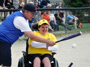 Jordan Sykes, with the help of dad Doug, was one of 15 participants at the opening night of West Perth Opti-Challenge Baseball held at Keterson Park on May 24. ANDY BADER/MITCHELL ADVOCATE