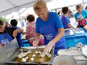 EMILY MOUNTNEY-LESSARD/Intelligencer file photo
Volunteers fry up Loukoumathes (deep-fried dough rolled in cinnamon and honey syrup) at the inaugural Opa Festival Saturday.