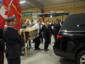 Ernst Kuglin/The Trentonian/The Intelligencer 
Pallbearers escort the casket to a waiting hearse shortly after the funeral service for five-term city Coun. Doug Whitney in Trenton Tuesday. The service was held at the Trenton Community Gardens. The fire department's colour party and members of the Trenton Golden Hawks Jr. a hockey team formed an honour guard.