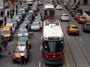 Taxi drivers park their cars three-deep on Queen Street West outside city hall during a protest against car-sharing service Uber in Toronto, Ontario June 1, 2015. REUTERS/Chris Helgren