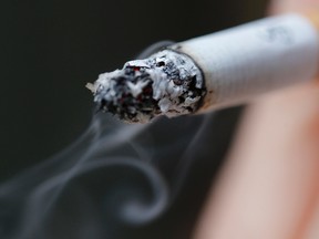 A woman smokes a cigarette. 

REUTERS/Christian Hartmann