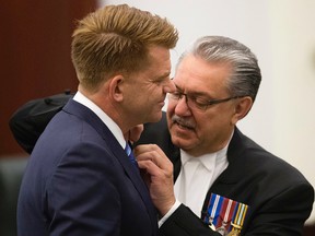 Wildrose leader Brian Michael Jean (MLA for Fort McMurray-Conklin) receives his mace pin from Speaker of the Alberta Legislative Assembly Gene Zwozdesky, as members of the Wildrose caucus are sworn-in at the Alberta Legislature, in Edmonton Alta. on Monday June 1, 2015. David Bloom/Edmonton Sun/Postmedia Network