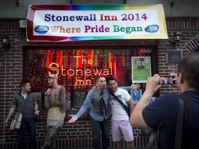 People pose for photos in front of the Stonewall Inn before the start of Pride Week activities in the Manhattan borough of New York June 27, 2014.
Reuters/Carlo Allegri