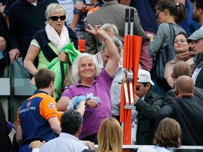 A spectator receives medical assistance after a metal panel collapsed in the stands on the Philippe Chartier tennis court during the men's quarterfinal match between Jo-Wilfried Tsonga and Kei Nishikori during the French Open in Paris on Tuesday, June 2, 2015. (Pascal Rossignol/Reuters)