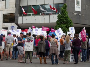 Some of London's 750 inside city workers rally outside of city hall on the first day of their strike in London, Ont. on Monday May 25, 2015. (DEREK RUTTAN, The London Free Press)