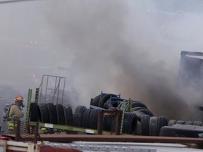 Kingston firefighters battle a blaze at Mulrooney Metal Recyclers Ltd. on McAdoo’s Lane in Kingston on Tuesday. (Elliot Ferguson/The Whig-Standard)