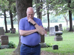 Thomas Wylie looks at the grave of James Barr Glen. Wylie is from Scotland and only knew that his great uncle had died on Lake Huron last year when he contacted Kathy Pletsch of the Great Lakes Storm of 1913 committee. (Laura Broadley Clinton News Record)