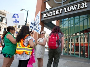 Striking city inside workers, members of CUPE 101, picket Richmond St. near Market Tower, where some picketers normally are employed at an Ontario Works office. With the strike in its second week, the city and union have scheduled renewed talks Friday, although the union is firm it its refusal to accept concessions. (CRAIG GLOVER, The London Free Press)