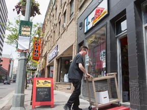 Gord Mood uses a StopGap ramp at his downtown business, L.A. Mood Comics and Games, on Richmond St. The StopGap London Community Ramp Project will provide free access ramps to local businesses to eliminate single-step barriers. The ultimate goal is to make businesses accessible for all. (DEREK RUTTAN, The London Free Press)