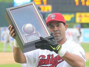 Winnipeg Goldeyes catcher Luis Alen hoists a framed game ball following a presentation in Winnipeg, Man. Tuesday June 02, 2015 after setting a Goldeyes' record for 632 hits.
Brian Donogh/Winnipeg Sun/Postmedia Network