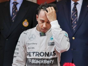 Mercedes Formula One driver Lewis Hamilton of Britain reacts on the podium after placing third in the Monaco Grand Prix in Monaco May 24, 2015. (ROBERT PRATTA/Reuters)