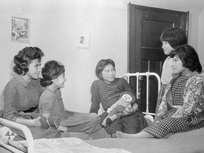 Girls sit on beds in a dormitory at the Shingwauk Indian Residential School in Sault Ste Marie, Ontario in a 1960 archive photo. A Canadian policy of forcibly separating aboriginal children from their families and sending them to residential schools amounted to "cultural genocide," a six-year investigation into the now-defunct system found on June 2, 2015. The residential school system attempted to eradicate the aboriginal culture and to assimilate aboriginal children into mainstream Canada, said the long-awaited report by the Truth and Reconciliation Commission of Canada. REUTERS/Department of Citizenship and Immigration-Information Division/Library and Archives Canada/PA-185528/handout via Reuters
