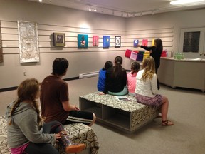 Students of the Next Chapter program took time during the last day of the program to visit the Gallery and speak with one of the artists.