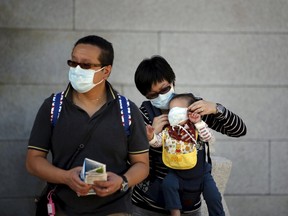 A Chinese tourist puts a mask on her child's face to prevent contracting Middle East Respiratory Syndrome (MERS) at the Gyeongbok Palace in central Seoul, South Korea June 3, 2015. South Korean President Park Geun-hye said on Wednesday everything must be done to stop MERS as fear of the disease shut hundreds of schools and led to corporate giant Samsung calling off a staff conference. REUTERS/Kim Hong-Ji