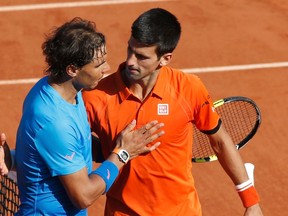 Novak Djokovic (right) greets Rafael Nadal (left) after winning their men's quarterfinal match during the French Open in Paris on Wednesday, June 3, 2015. (Jean-Paul Pelissier/Reuters)