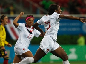 Canada's Robyn Gayle (R) celebrates her goal against Colombia with teammate Desiree Scott (C) during the women's soccer semifinal at the Pan American Games in Guadalajara October 25, 2011. (REUTERS/Alejandro Acosta)