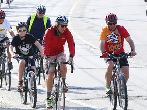 Paul Brunelle, right, chats with his former student athlete and Olympic Nordic skier Devon Kershaw (middle) while his grandson Jacob Demore (left) tags along during the Share the Road Ride in Sudbury last Thursday. Brunelle will be inducted into the Sudbury Sports Hall of Fame next Wednesday.