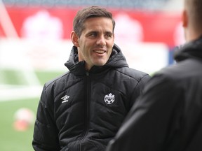 National women's soccer team head coach John Herdman awaits the start of a team practice at Investors Group Field in Winnipeg, Man., on Wed., May 7, 2014, ahead of its friendly against the United States. (Kevin King/Winnipeg Sun/Postmedia Network)