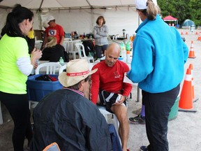 Rick VanVlack (red shirt) gets some attention from his support staff during the 100-mile Sulpher Springs Trail Race at the Dundas Valley Conservation Area just outside of Hamilton a couple of weeks ago. Submitted photo
