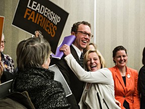 NDP leader Rachel Notley, centre right, hugs Edmonton-Goldbar candidate Marlin Schmidt during the NDP's provincial council at the Coast Edmonton Plaza Hotel in Edmonton, Alta., on Saturday, Jan. 31, 2015. Codie McLachlan/Edmonton Sun