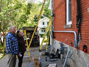 Jim Pulcine (left) and his wife Veronica Onyskiw look at the damage where their hydro smart meter was formerly attached to their home, June 3, 2015. (PAUL BRIAN/Postmedia Network)