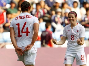 Canada's Melissa Tancredi (14) celebrates with Diana Matheson after Tancredi scored a goal during their women's Group F football match at the London 2012 Olympic Games in Coventry July 25, 2012. (REUTERS/Alessandro Garofalo)