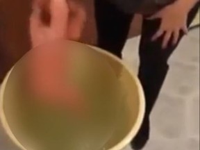 A baby is churned in a bucket of water in a video posted to social media.