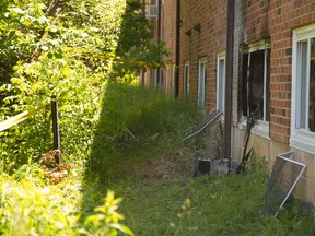 Scene of fatal fire at Langarth Street E, the air conditioner is sitting on the grass outside the soot darkened apartment.  (Mike Hensen/The London Free Press)