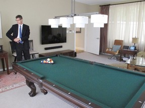 UBC president Arvind Gupta had the pool table brought in, a "chandelier" light fixture installed above it, a new flatscreen TV and the two iPad stations brought into the shared multimedia room in the public portion of the house.  Also pictured is UBC infrastructure development managing director John Metras. 
Michael Mui, 24 hours