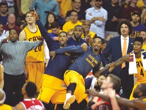Cavaliers' (left to right) Tristan Thompson, LeBron James and J.R. Smith celebrate on the bench, (USA TODAY SPORTS)